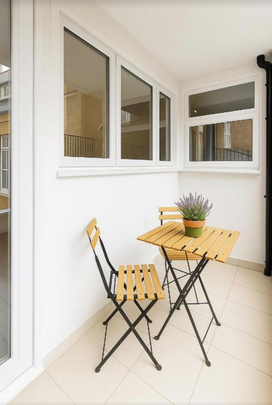 Private terrace with a folding bistro table and two chairs
