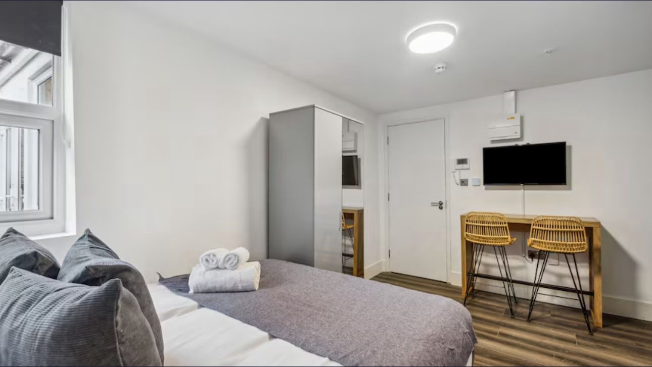 Studio with a sofa, dining bar and bed
